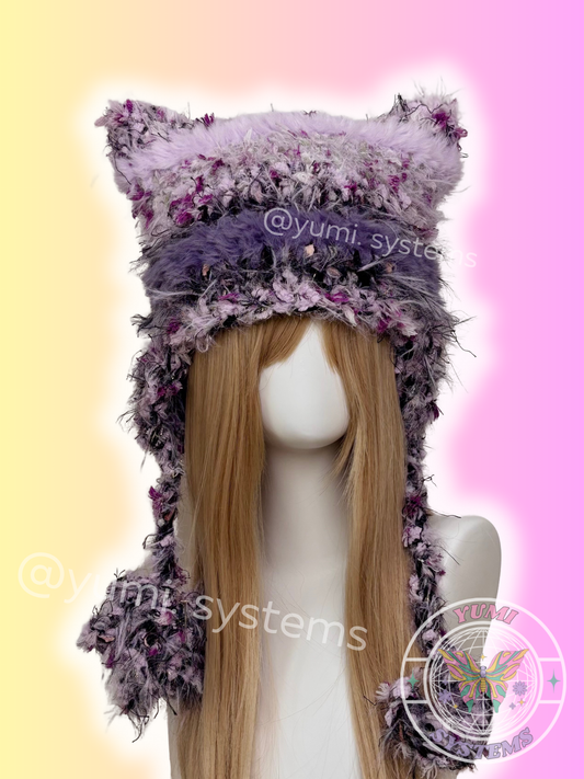 Three variations of heavy handmade crochet cat ear beanies: Lavender Purple, Earthy Moss, and Midnight Black with fuzzy trim.