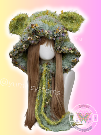  High-density handmade fuzzy cat and bunny ear modular aviator beanies in various multi-tonal colorways on a mannequin.